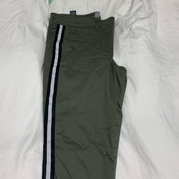 black pants with green side stripe